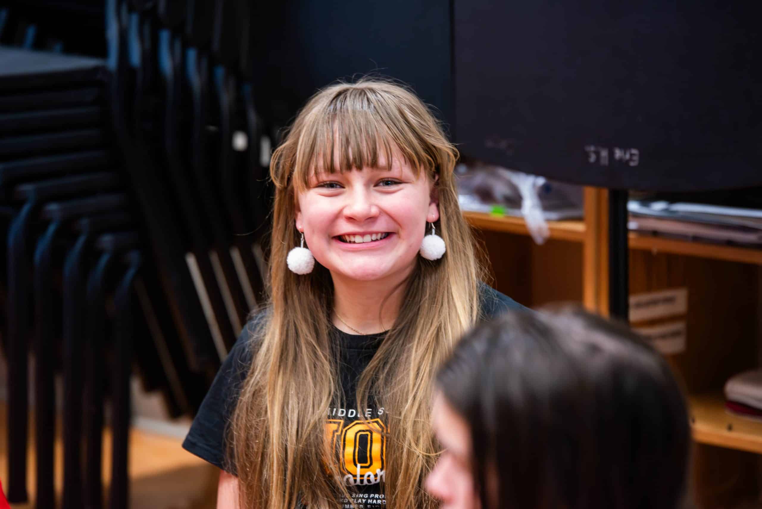 Female student smiles during drama workshop at Theater Day