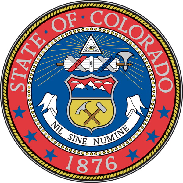 "Colorado State Seal with a red outer ring containing the words 'State of Colorado' at the top and '1876' at the bottom. The ring is bordered by small blue stars. Inside the center shield, the top section shows a snow-capped mountain range, and the bottom section has crossed tools: a pickaxe and sledgehammer. Below the shield is a banner with the Latin motto 'Nil Sine Numine' meaning 'Nothing without providence.' Above the shield is a Roman fasces symbolizing governance, with the words 'Union and Constitution,' and an eye enclosed in a triangle, representing the Eye of Providence, radiating light."